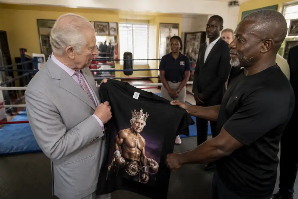 Koning Charles krijgt zwart shirt met eigen afbeelding bij bezoek aan boksschool op Bahama's